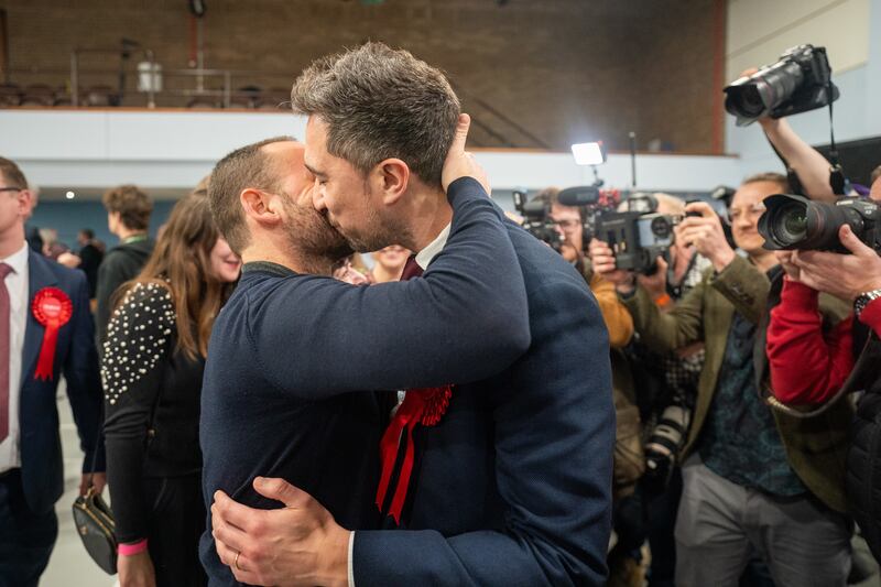 Labour candidate Damien Egan shares a kiss with his husband Yossi Felberbaum after being declared MP for Kingswood