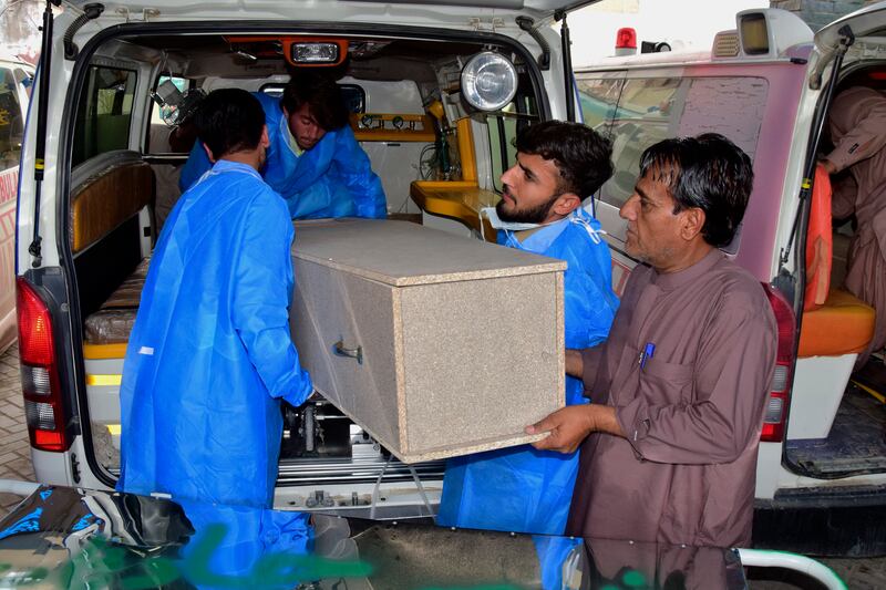 Hospital staff and volunteers unload a coffin from an ambulance in Quetta (Arshad Butt/AP)