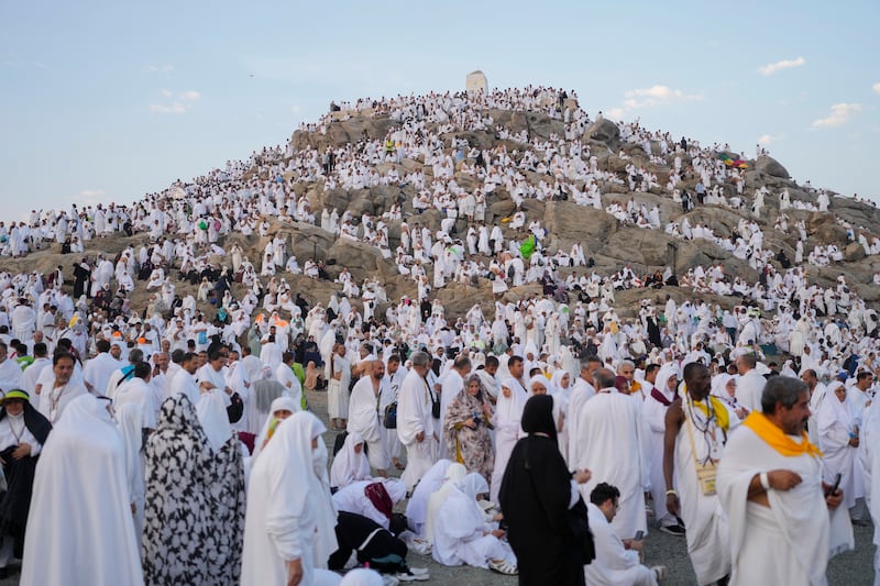 Muslim pilgrims gather at the top of the rocky hill known as the Mountain of Mercy, on the Plain of Arafat, during the annual Hajj pilgrimage (Rafiq Maqbool/AP)