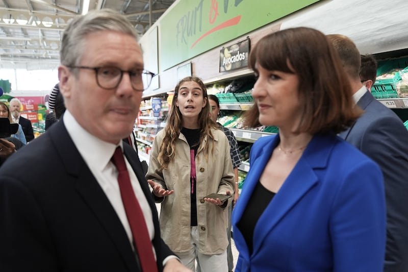 A shopper (centre) questions Labour Party leader Sir Keir Starmer and shadow chancellor Rachel Reeves about climate change, during a visit to Morrisons in Wiltshire