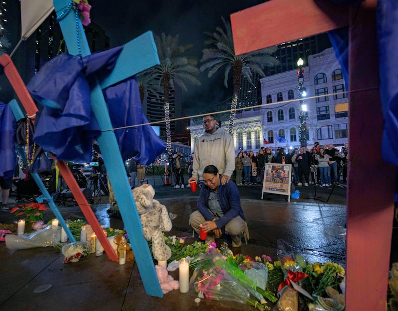 Large crosses have been erected in honour of those who were killed (Matthew Hinton/AP)