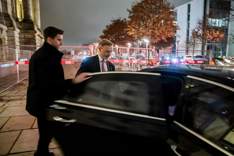 Germany’s minister of finance Christian Lindner, right, gets into his limousine in front of the Reichstag building after his dismissal (Christoph Soeder/AP)