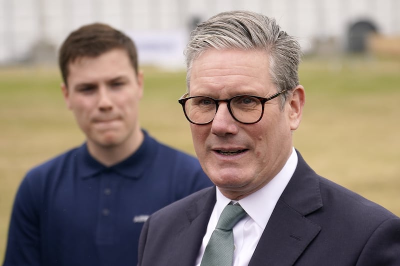 Prime Minister Sir Keir Starmer speaks to employees, as he arrives at the Farnborough International Airshow