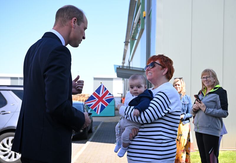 The Prince of Wales greets well-wisher Andrea Newton and her grandson as he leaves Low Carbon Materials in Seaham, County Durham