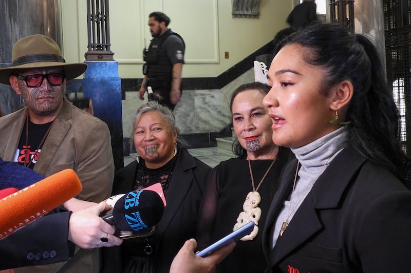 Hana-Rawhiti Maipi-Clarke, right, and her colleagues from Te Pati Maori, talk to reporters following a protest inside parliament in Wellington, New Zealand (Charlotte Graham-McLay/AP)