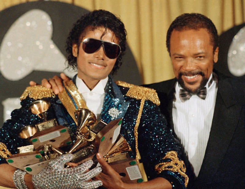 Michael Jackson, left, holds eight awards as he poses with Quincy Jones at the Grammy Awards in Los Angeles in 1984 (Doug Pizac/AP)