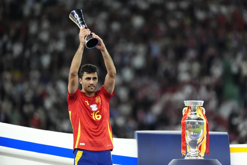 Rodri with the player of the tournament trophy after helping Spain with Euro 2024 in July