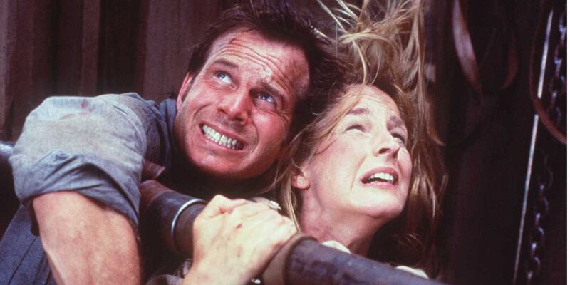 Bill Paxton and Helen Hunt cower from a tornado in a scene from 1996's Twister