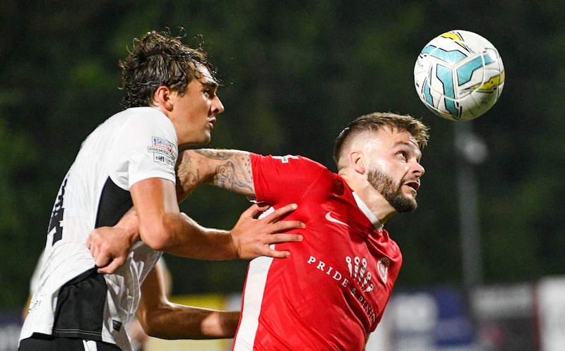 Andy Ryan of Larne holds off Frankie Hvid of Glentoran during this evening’s game at Inver Park, Larne