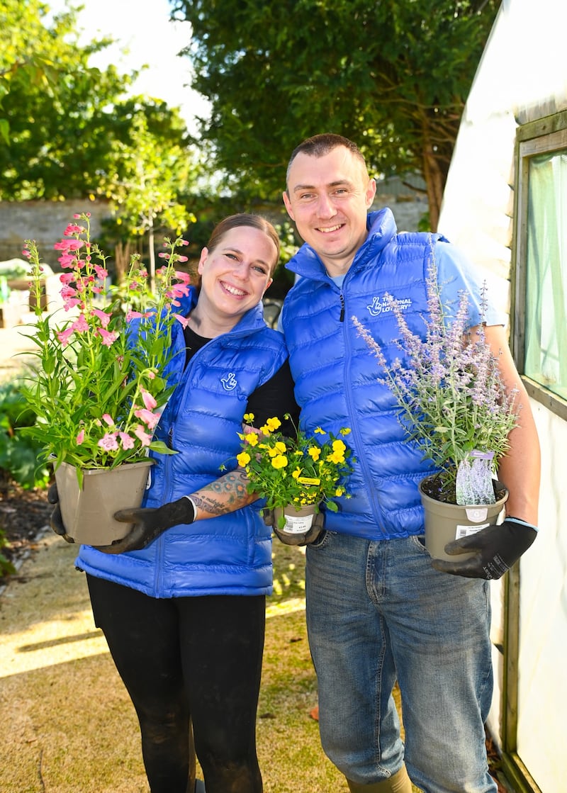 Lottery winners Katherine and Graeme White help spruce up a garden for toddlers at Sacrewell Farm in Peterborough.