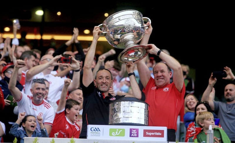 Tyrone&#39;s joint-managers Brian Dooher and Feargal Logan lift the Sam Maguire. Picture: Seamus Loughran. 