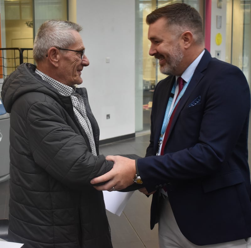 Danny Davey is congratulated by Suffolk New College Principal and CEO Alan Pease, having achieved a GCSE in English aged 73.