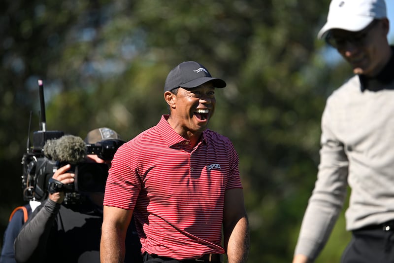 Tiger Woods (centre) reacts to his son Charlie’s hole-in-one on the fourth hole during the final round of the PNC Championship (Phelan M. Ebenhack/AP)