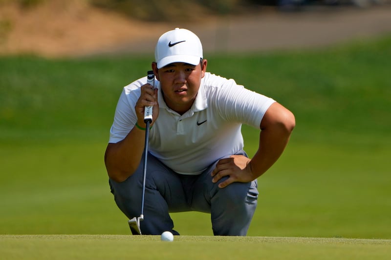 Tom Kim lines up a putt on the 15th hole (Seth Wenig/AP)