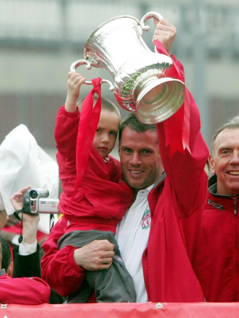 James Carragher holds the FA Cup with father Jamie after Liverpool won the FA Cup in 2006