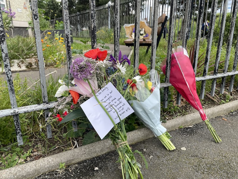 Floral tributes and messages of condolence were left outside the apartment block following the incident