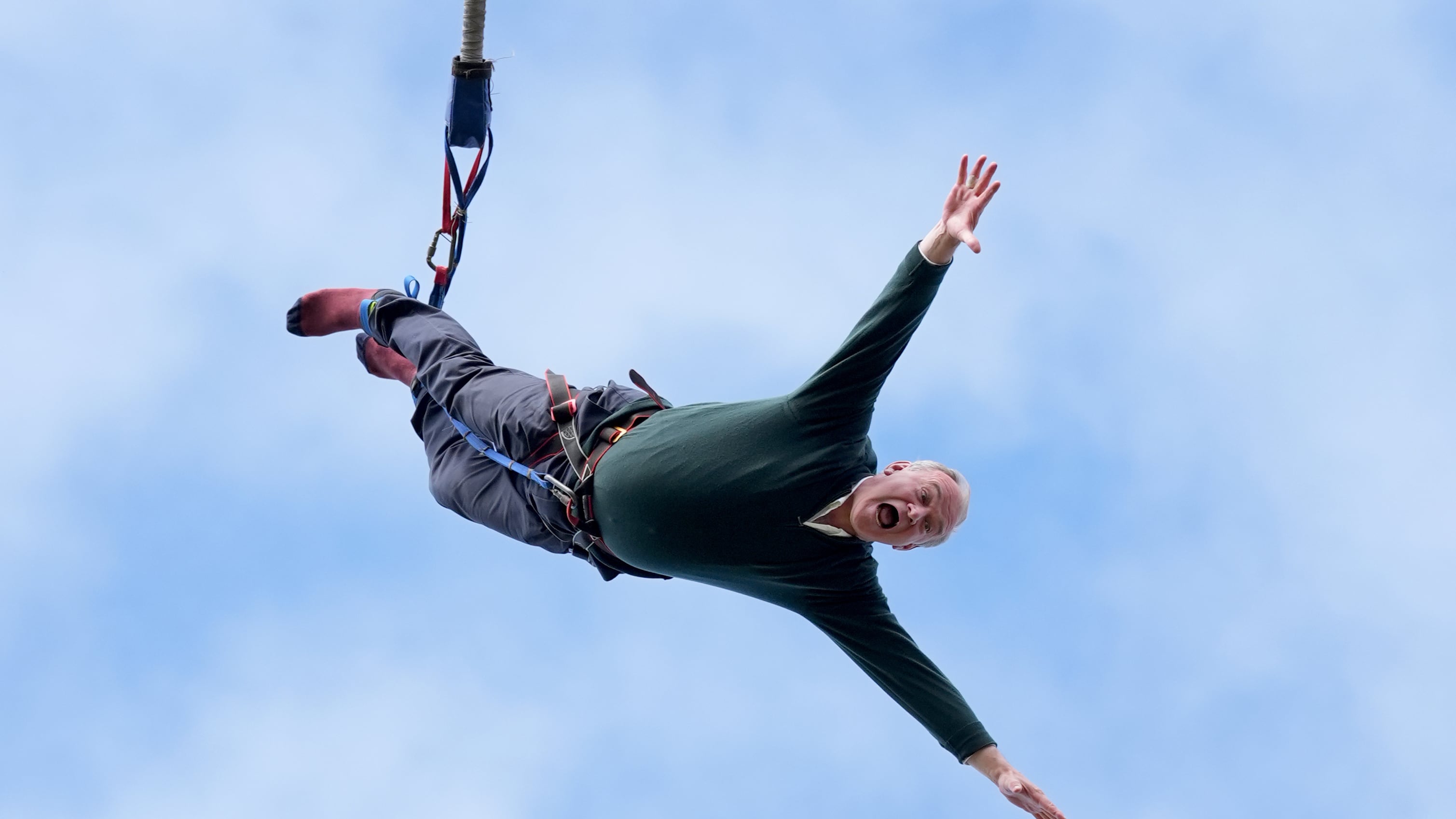 Liberal Democrat leader Sir Ed Davey taking part in a bungee jump