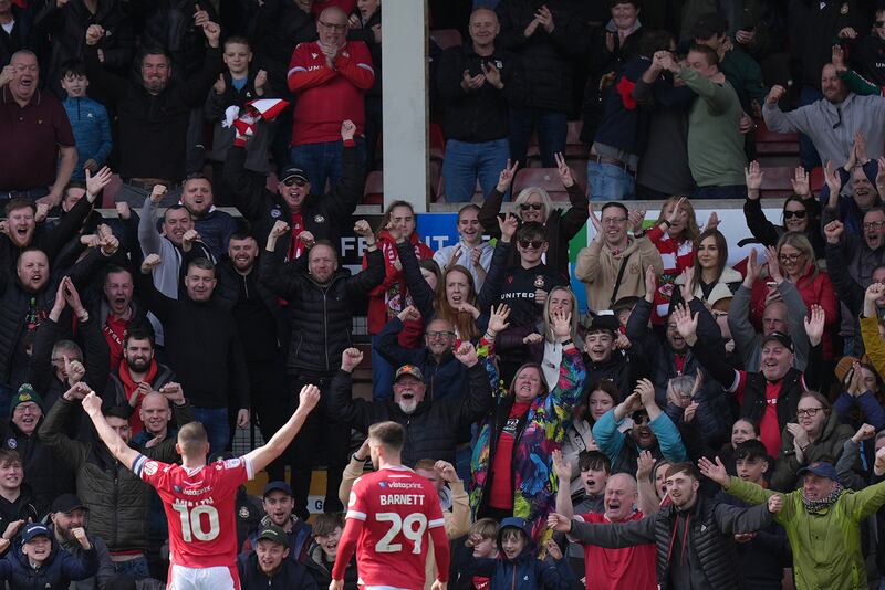 Wrexham’s Paul Mullin (left) celebrates in front of the fans .