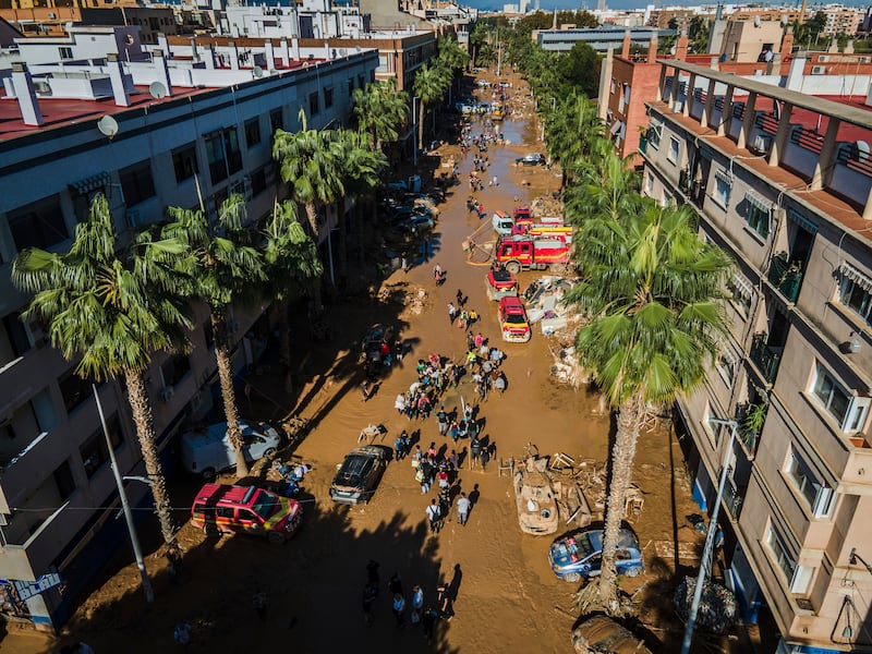 Volunteers and residents in Valencia clean the mud four days after flash floods (Angel Garcia/AP)