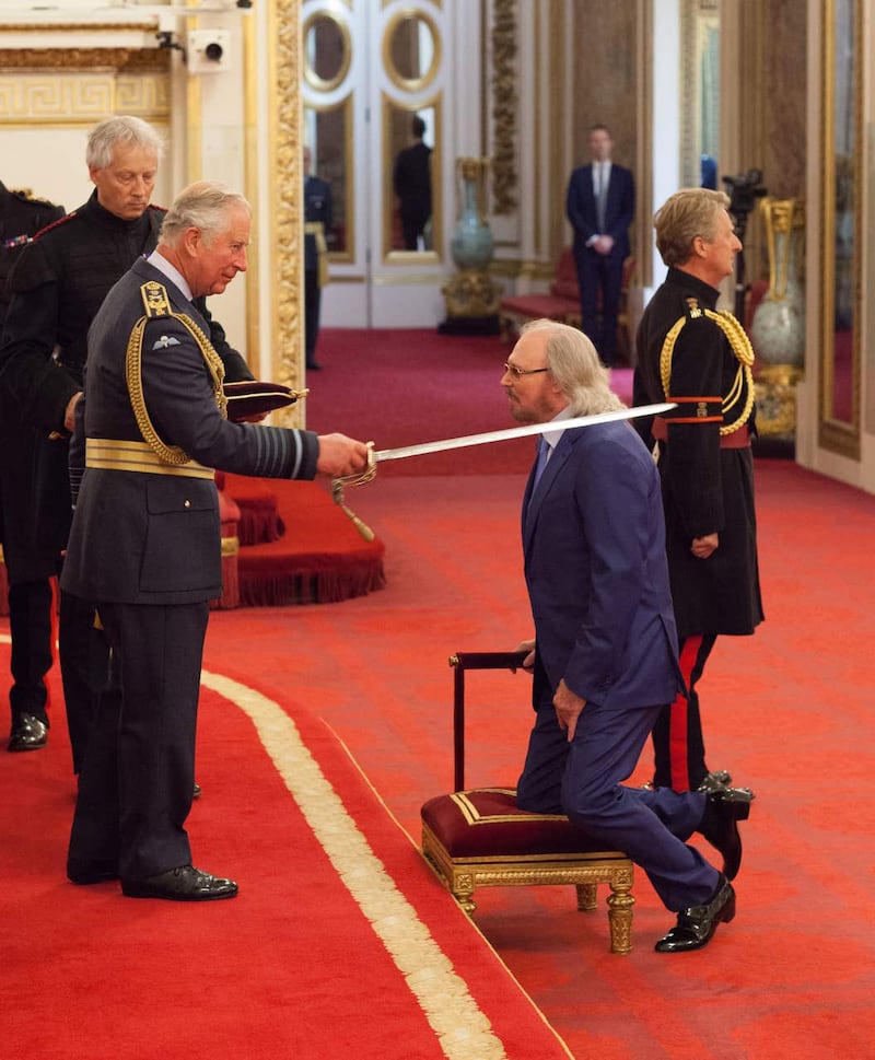 Singer and songwriter Barry Gibb is knighted by the Prince of Wales 