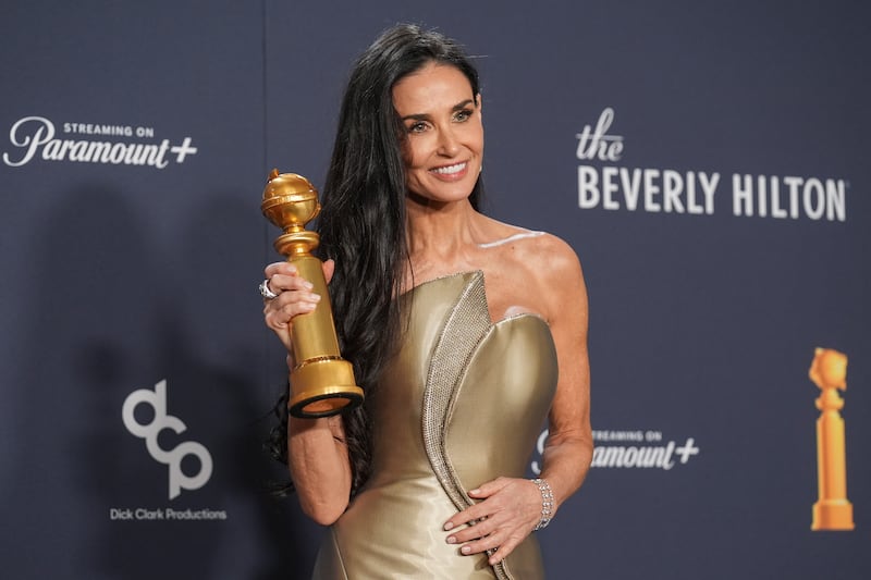 Demi Moore poses in the press room with the award for best performance by a female actor in a motion picture – musical or comedy for The Substance (Chris Pizzello/AP)