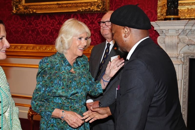 Camilla greeted key supporters of the charity, including poet and novelist Sir Ben Okri (right) during a reception to celebrate its 70th anniversary