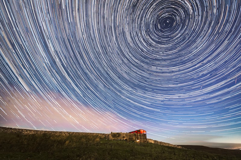 Using a camera with a long exposure over a long period of time is the best way to capture meteor showers and may produce star trail photographs