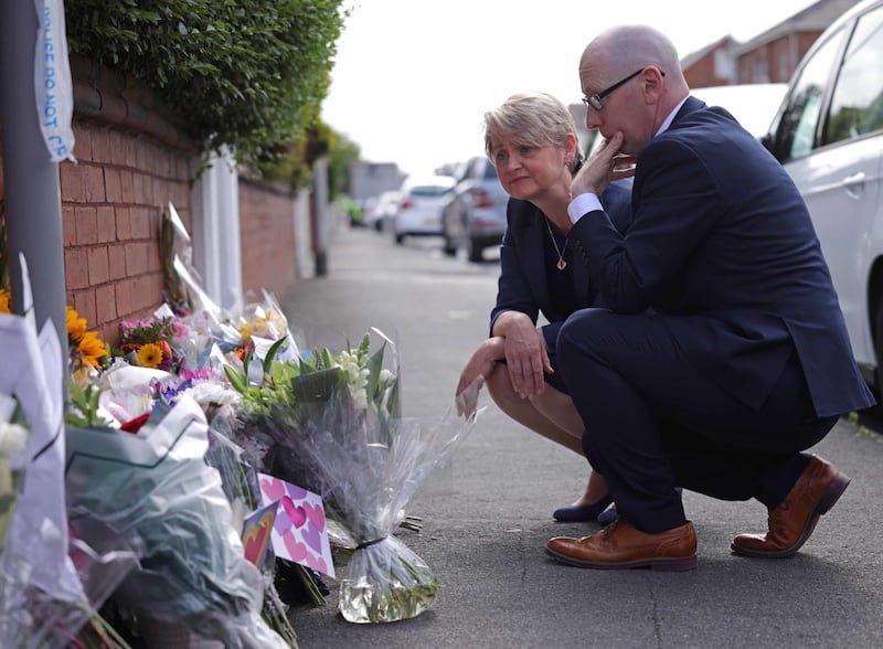 Home Secretary Yvette Cooper looks at tributes near the scene in Hart Street where three children died and nine were injured in a knife attack