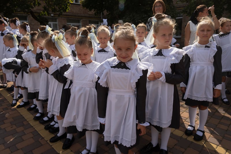 Schoolgirls attend the first day at school in a cadet lyceum in Kyiv, Ukraine (Efrem Lukatsky/AP)