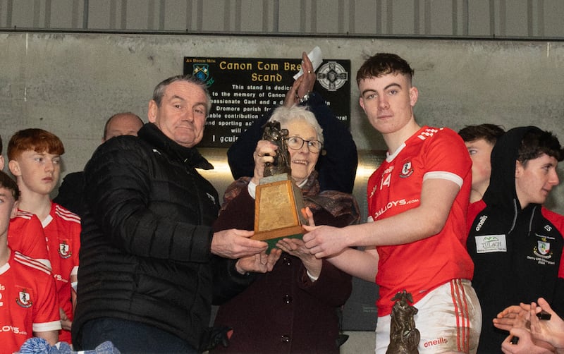 Ulster President Ciarán McLaughlin and  Rita McGirr present the Paul McGirr trophey to Maherafelt captain Kian Maynes