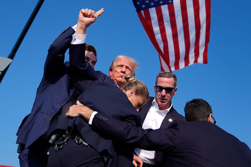 Former President Donald Trump is surrounded by US Secret Service agents (Evan Vucci/AP)