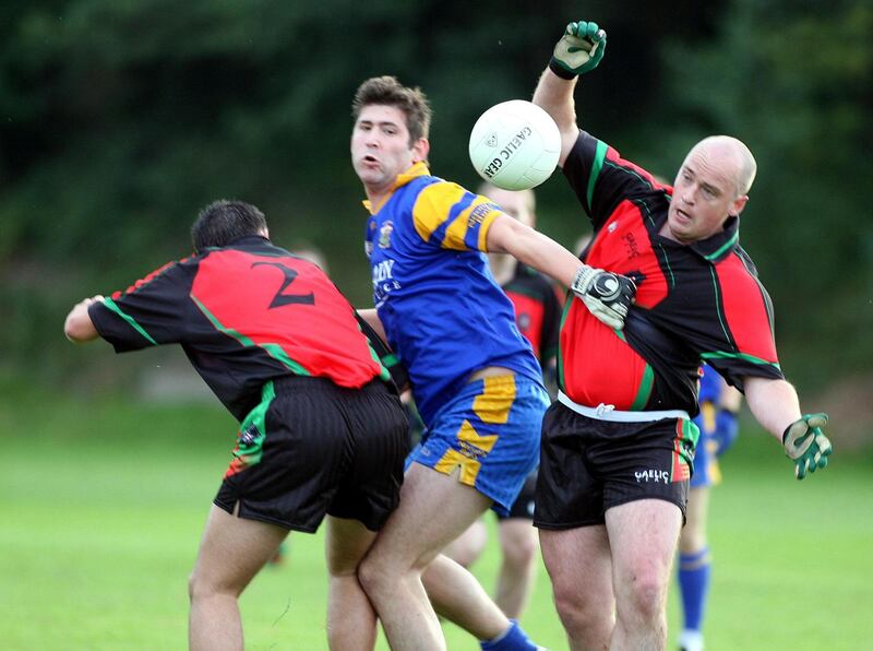 Former PSNI GAA team captain Peadar Heffron (right) fighting for control of the ball in a game against St Brigid’s in south Belfast four years before his injuries
