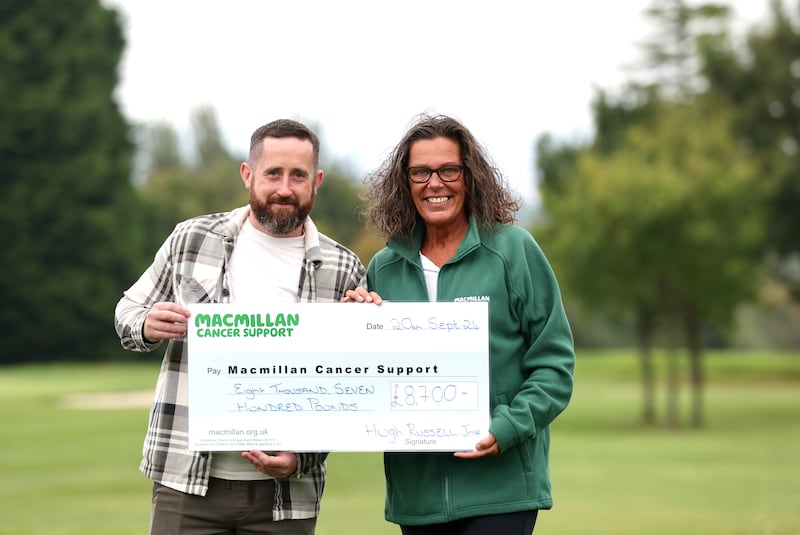 Hugh Russell Jnr and Joanne Young from Macmilllan Cancer as the Russell Family hand over a cheque to the Charity after a charity Golf Day.
PICTURE COLM LENAGHAN