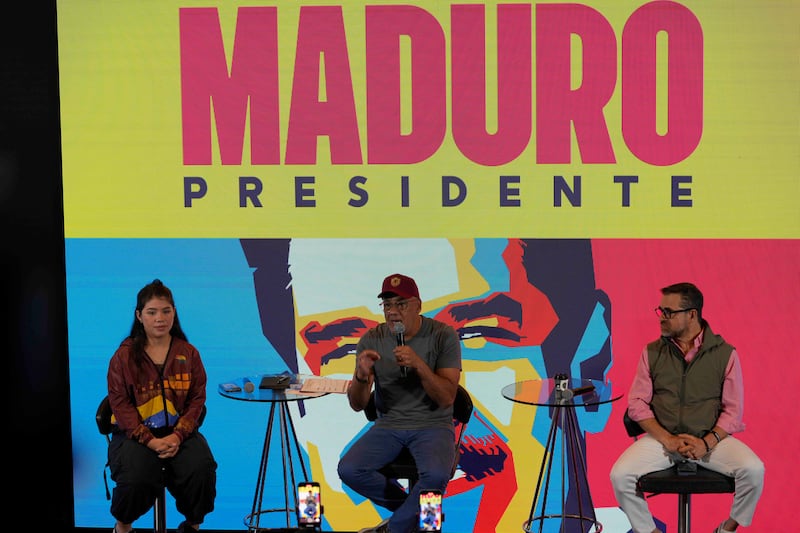 President of Venezuela’s National Assembly Jorge Rodriguez speaks during a press conference alongside legislator Genesis Garvett, left, and Governor Rafael Lacava in Caracas (Ariana Cubillos/AP)