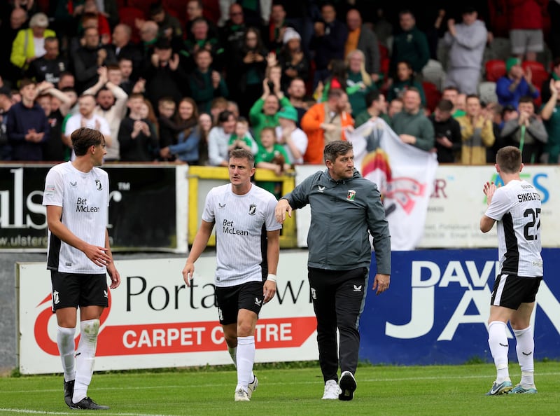 Glentoran manager Declan Devine celebrates with the travelling fans at Shamrock Park