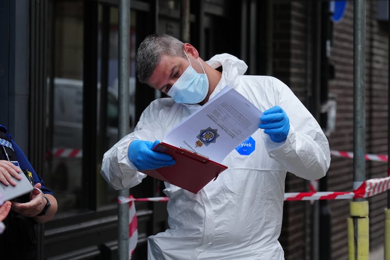 Police forensic investigators enter a disused building in Fore Bondgate