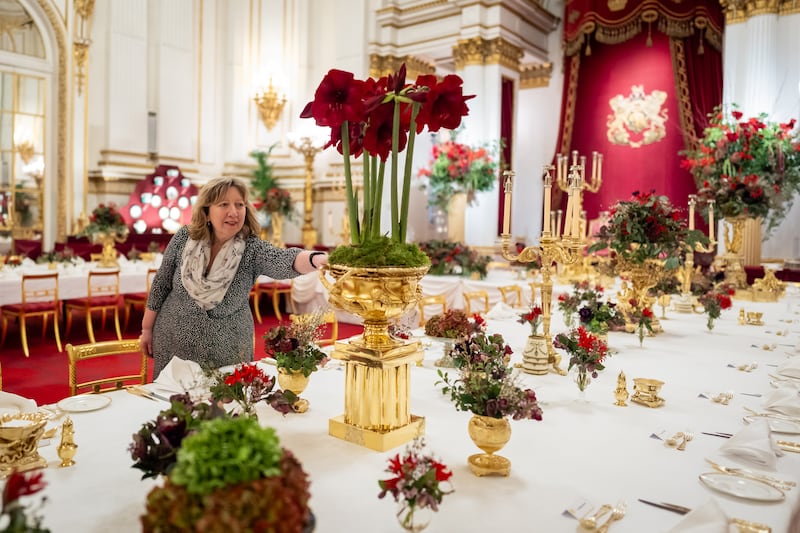 A royal florist checks the table ready for the banquet