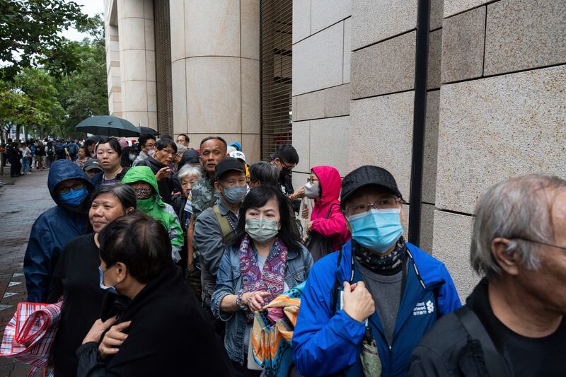 More than 200 people queued in rain and winds on Tuesday for a seat in the hearing (Chan Long Hei/AP)