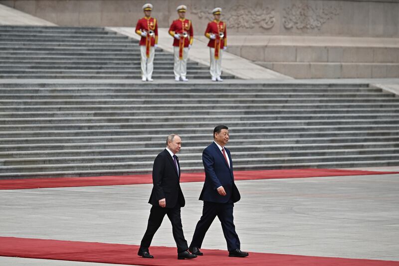 Chinese President Xi Jinping, and Russian President Vladimir Putin walk on the red carpet (Sergei Bobylev, Sputnik, Kremlin Pool Photo via AP)