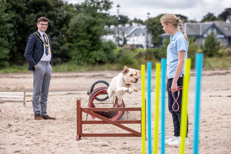 24/08/24 REPRO FREE.. Mayor of Causeway Coast & Glens Borough Council Cllr Ciaran McQuillans watches Ellie Park with her dog.

Crowds of locals and visitors made their way to the Lammas Fair this bank holiday weekend.

Events on the Saturday started the fair weekend off with a beach dog ability display, a new addition for 2024. Market stalls lined the streets as visitors enjoyed the Naturally North Coast and Glens Artisan Market.
Mayor of Causeway Coast and Glens Councillor Ciarán McQuillan presented the heavy horse show prizes and also met with the many visitors who came along for the long weekend. Pictures Causeway Coast & Glens Borough Council