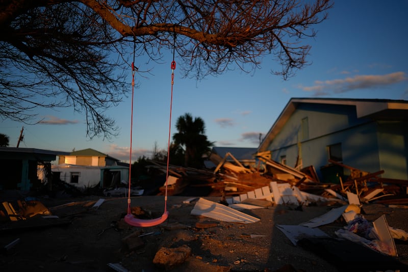 A child’s swing still hangs on a tree, surrounded by debris from homes destroyed by Hurricane Milton (AP/Rebecca Blackwell)