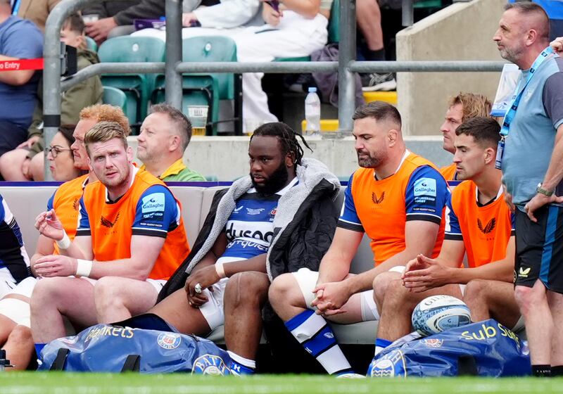 Beno Obano (centre) sits on the bench after being sent off