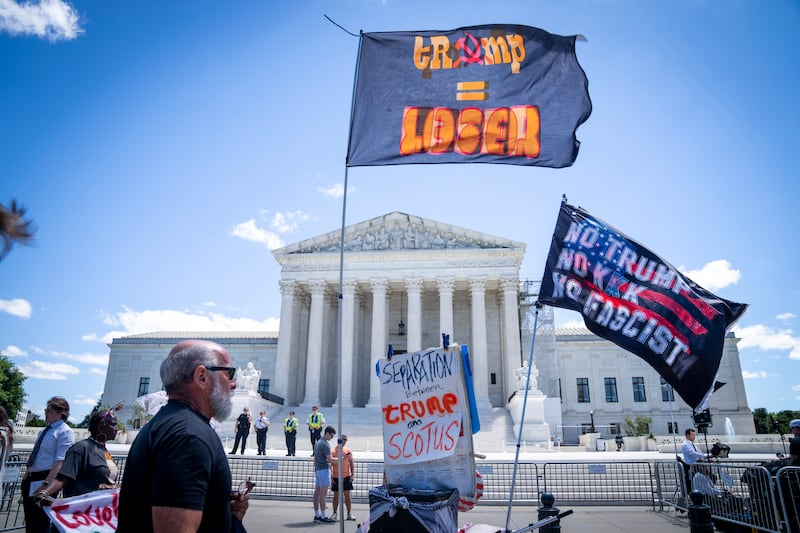 People protest outside of the US Supreme Court in Washington, DC on Monday (Jacquelyn Martin/AP)