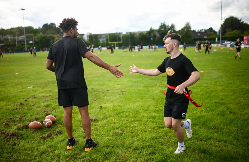 Pittsburgh Steelers tight end Connor Heyward high fiving a participant at the Steelers Youth Camp in Belfast