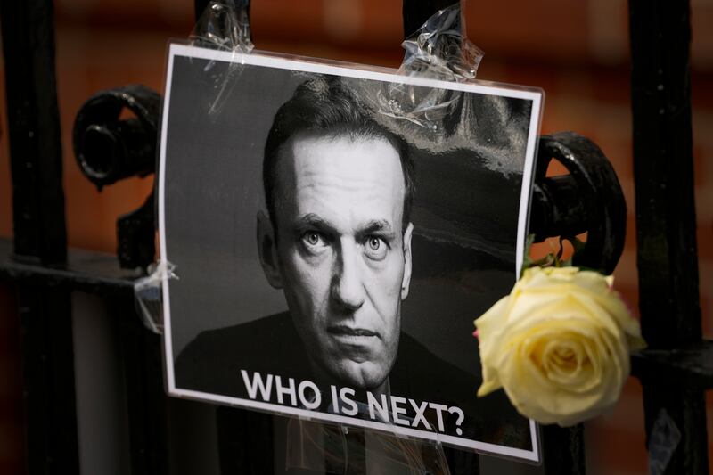 A tribute to Alexei Navalny near the Russian embassy in London (Kirsty Wigglesworth/AP)