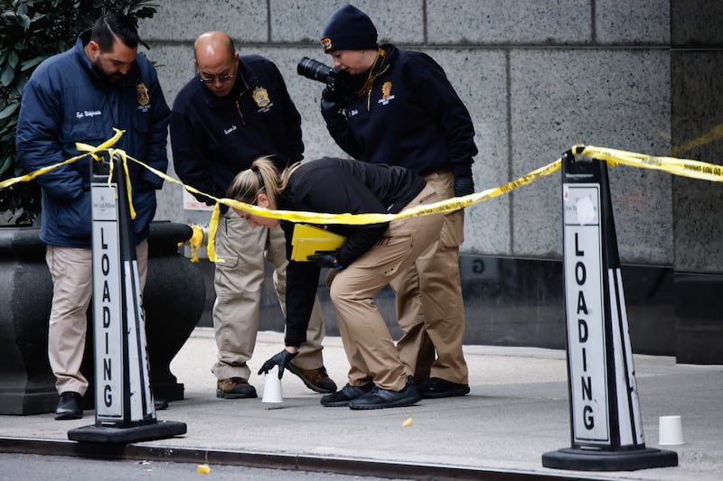 Members of the New York police crime scene unit investigate the scene where Brian Thompson was killed (AP Photo/Stefan Jeremiah)