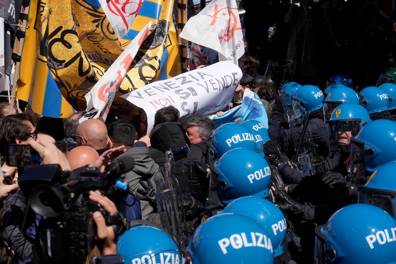 Citizens and activists confront police during a demonstration against the day-tripper tax in Venice (Luca Bruno/AP)