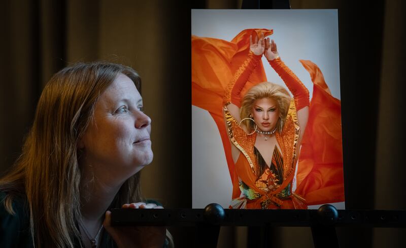 Vicky Robayna with photographs of a cast member of RuPaul’s Drag Race UK, taken by her daughter