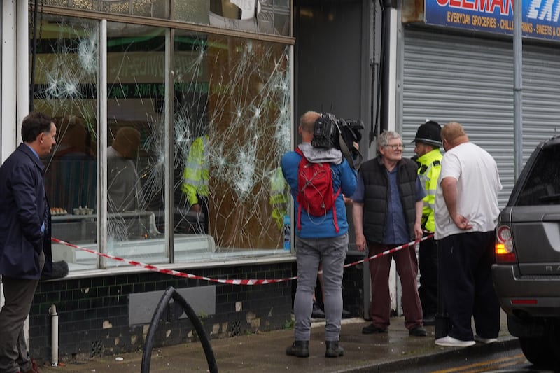 Police officers outside a damaged butchers shop on Murray Street in Hartlepool following an evening of unrest