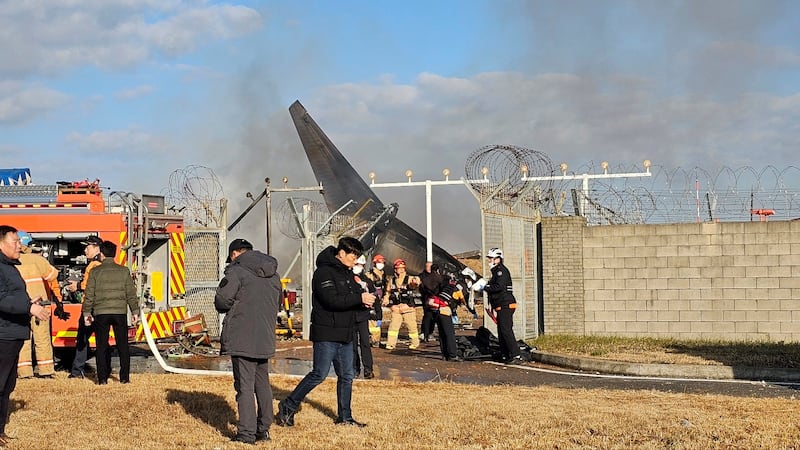 Firefighters and rescue team members work at the Muan International Airport (Maeng Dae-hwan/Newsis/AP)